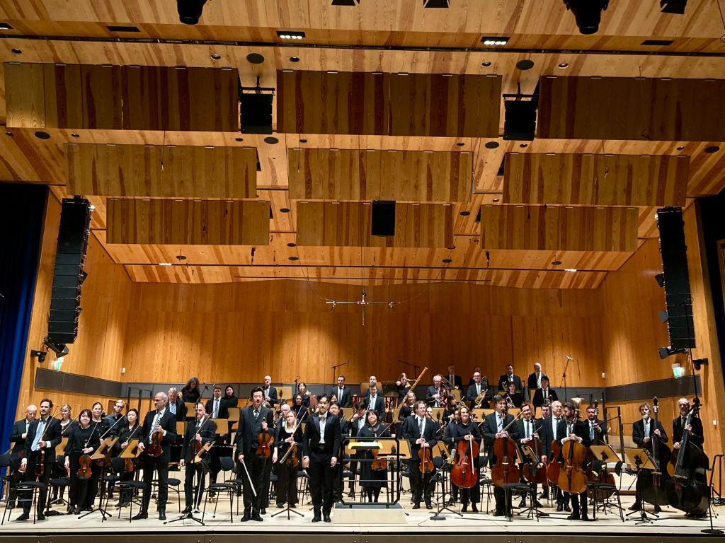 Orchestra bow on wooden concert stage